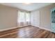 Bedroom featuring hardwood floors, large windows, and closet with double doors at 411 Burke Cir, Mcdonough, GA 30253