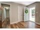 Bright foyer showcasing wood floors, neutral walls, and a view into the hallway at 411 Burke Cir, Mcdonough, GA 30253