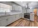 Bright kitchen featuring light cabinets, tile backsplash, stainless steel appliances, and wood floors at 411 Burke Cir, Mcdonough, GA 30253