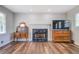 Cozy living room showcasing a fireplace with decorative marble tiling and beautiful hardwood floors at 411 Burke Cir, Mcdonough, GA 30253