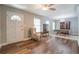 Sunlit living room features wood floors, neutral walls, and a decorative display cabinet at 411 Burke Cir, Mcdonough, GA 30253