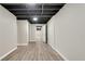 Finished basement with updated flooring, neutral paint and exposed ceiling at 4159 King Valley Se Dr, Smyrna, GA 30082