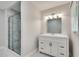 Well-lit bathroom with gray walls, white vanity and a glass-enclosed shower at 4159 King Valley Se Dr, Smyrna, GA 30082