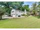 The rear exterior view of a two-story home with a brick facade and a well-maintained lawn at 4159 King Valley Se Dr, Smyrna, GA 30082