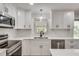 Modern kitchen featuring white cabinets, stainless steel appliances, and a subway tile backsplash at 4159 King Valley Se Dr, Smyrna, GA 30082