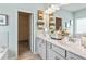 Bright bathroom featuring double vanity, soaking tub, and a decorative shelf for towels at 640 Blackshear Trl, Temple, GA 30179