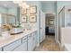 Bright bathroom featuring double vanity, an open doorway, and a shower with glass doors at 640 Blackshear Trl, Temple, GA 30179