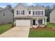 Charming two-story home with stone accents, an attached garage, and a well-manicured lawn at 640 Blackshear Trl, Temple, GA 30179