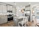 Stylish eat-in kitchen with stainless steel appliances, granite countertops, a center island, and modern lighting at 640 Blackshear Trl, Temple, GA 30179