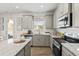 Modern kitchen featuring stainless steel appliances, granite countertops, and ample cabinet space for storage at 640 Blackshear Trl, Temple, GA 30179