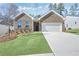 Charming brick home with a well-manicured front lawn and a two-car garage at 159 Park Lane, Fairburn, GA 30213