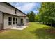 Serene backyard patio with seating, sunroom, and expansive grassy lawn at 200 Bexley Pkwy, Tyrone, GA 30290