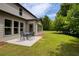 Relaxing backyard patio featuring outdoor seating, a lush lawn, and mature trees offering shade at 200 Bexley Pkwy, Tyrone, GA 30290