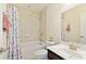 A cozy bathroom with a shower/tub combo, toilet, sink, and decorative shower curtain at 200 Bexley Pkwy, Tyrone, GA 30290