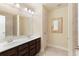 Bathroom featuring a double sink vanity with wood cabinets and a mirror at 200 Bexley Pkwy, Tyrone, GA 30290