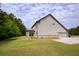 Side view of the home highlighting the siding, attached garage, and well-maintained lawn at 200 Bexley Pkwy, Tyrone, GA 30290