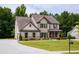 Inviting two-story home featuring a manicured lawn, brick accents and a covered porch at 200 Bexley Pkwy, Tyrone, GA 30290