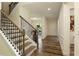 Elegant foyer featuring hardwood floors, a staircase with iron railings, and neutral walls at 200 Bexley Pkwy, Tyrone, GA 30290