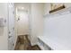 Well-lit mud room featuring white storage bench with hooks and view down hallway at 200 Bexley Pkwy, Tyrone, GA 30290