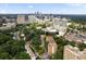 Aerial view showcasing the Slaton Manor Condominiums amidst mature trees and a cityscape backdrop at 2965 Pharr Court South Nw # 712, Atlanta, GA 30305