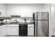 Well-maintained kitchen with black countertops, white cabinets, and stainless steel refrigerator at 2965 Pharr Court South Nw # 712, Atlanta, GA 30305