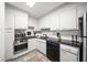 Compact kitchen with white cabinets, modern appliances, and tile flooring at 2965 Pharr Court South Nw # 712, Atlanta, GA 30305