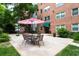 Outdoor patio with a dining set and a relaxing spot for dining, surrounded by lush greenery at 2965 Pharr Court South Nw # 712, Atlanta, GA 30305