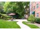 Outdoor patio area featuring dining furniture, lush greenery, and a tranquil setting for relaxation and socializing at 2965 Pharr Court South Nw # 712, Atlanta, GA 30305