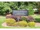 Community sign for Slaton Manor Condominium surrounded by vibrant landscaping and lush greenery at 2965 Pharr Court South Nw # 712, Atlanta, GA 30305