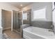 Well-appointed bathroom featuring a separate shower and tub, complemented by tile accents and ample natural light at 407 After Glow Smt, Canton, GA 30114