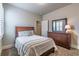 Cozy bedroom with neutral walls, plush carpeting, and a wooden dresser with mirror at 407 After Glow Smt, Canton, GA 30114