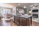 Open-concept kitchen with a large island and stainless steel appliances, adjacent to dining and living spaces at 407 After Glow Smt, Canton, GA 30114