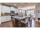 Well-lit kitchen with an island, granite countertops, stainless appliances, and hardwood floors at 407 After Glow Smt, Canton, GA 30114