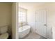 Bathroom with a freestanding tub next to a window, and white shiplap at 2192 Stenger Rd, Douglasville, GA 30135