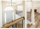 Open foyer with chandelier, white door, and wood-and-black railing near a brick fireplace at 2192 Stenger Rd, Douglasville, GA 30135