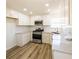 Well-lit kitchen featuring white cabinets, stainless steel appliances, and grey countertop at 2192 Stenger Rd, Douglasville, GA 30135