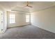 Main bedroom featuring carpeted floors, tray ceiling, and windows providing natural light at 2192 Stenger Rd, Douglasville, GA 30135
