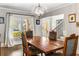 Elegant dining room with a wooden table, stylish chandelier, and large bright windows at 2217 Virginia Ne Pl, Atlanta, GA 30305