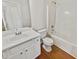 Bright bathroom featuring a shower and tub combo with a white vanity and wood look flooring at 380 Birchmere Sw, Atlanta, GA 30331
