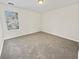 Spacious bedroom featuring neutral paint, plush carpeting, and a ceiling light fixture at 380 Birchmere Sw, Atlanta, GA 30331