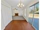 Dining area with wood floors features a sliding door, modern light fixture, and view of the living room at 380 Birchmere Sw, Atlanta, GA 30331
