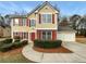 Charming two-story home with red shutters and a well-manicured front yard with mature shrubs at 380 Birchmere Sw, Atlanta, GA 30331