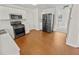 Modern kitchen featuring stainless steel appliances, white cabinetry, and durable vinyl flooring at 380 Birchmere Sw, Atlanta, GA 30331