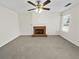 Spacious living room featuring a fireplace, neutral carpet, ceiling fan, and ample natural light at 380 Birchmere Sw, Atlanta, GA 30331