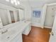 Large bathroom featuring a double sink, soaking tub, and shower, complemented by wood-look floors at 380 Birchmere Sw, Atlanta, GA 30331