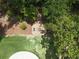 Aerial view of a brick paver patio with an outdoor fire pit and built-in benches at 4079 Bullock Bridge Rd, Loganville, GA 30052