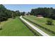 View of the property showcasing its expansive, well-maintained lawn and beautiful fencing at 4079 Bullock Bridge Rd, Loganville, GA 30052