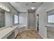 Bathroom featuring wallpaper, a tub, double sink vanity, and shower with gold-framed door at 4270 Fallbrook Dr, Duluth, GA 30096