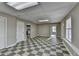 Large bonus room featuring checkerboard flooring, neutral walls, and multiple entryways at 4270 Fallbrook Dr, Duluth, GA 30096