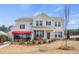 Beautiful two-story home with manicured lawn, brick accents, covered porch, and professionally landscaped front yard at 5955 Misty Hill Ln, Buford, GA 30518